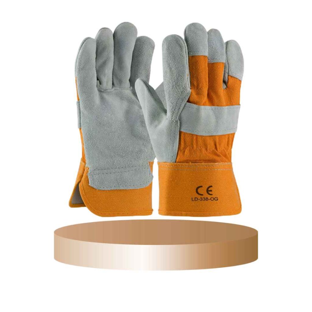 Orange and gray leather safety work gloves displayed on a round platform.
